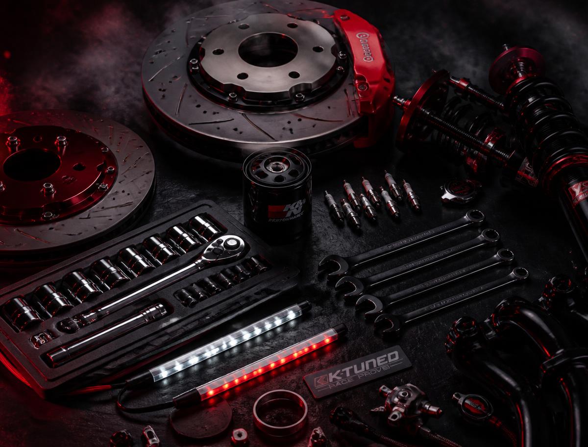 Automotive tools and car parts arranged on a workbench